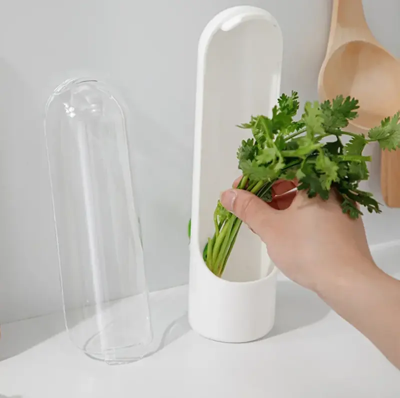 Three clear herb keepers holding fresh herbs in a fridge door