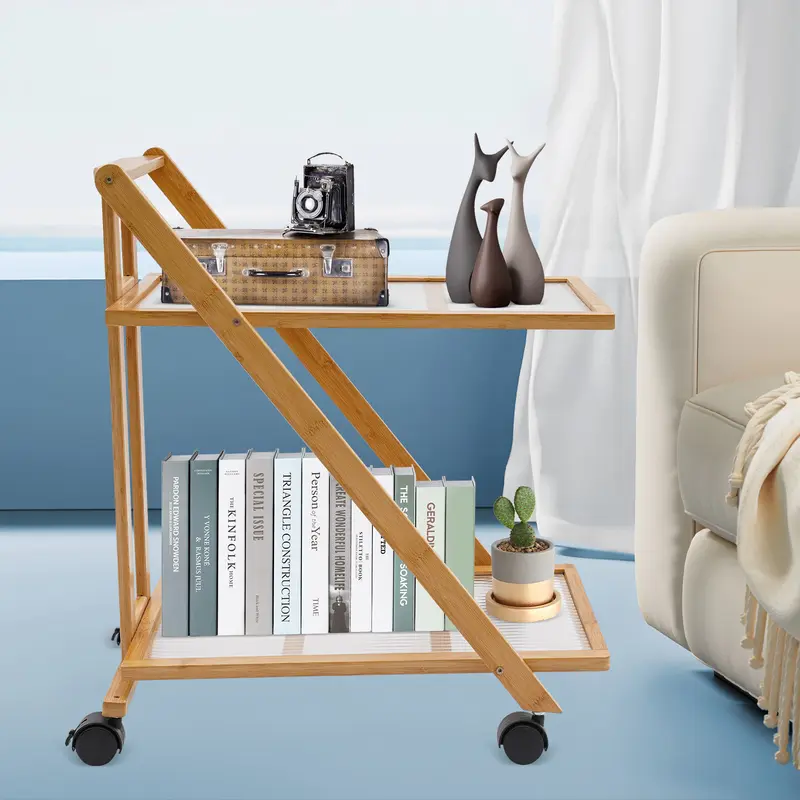 Two-tier folding bamboo cart with books beside a sofa