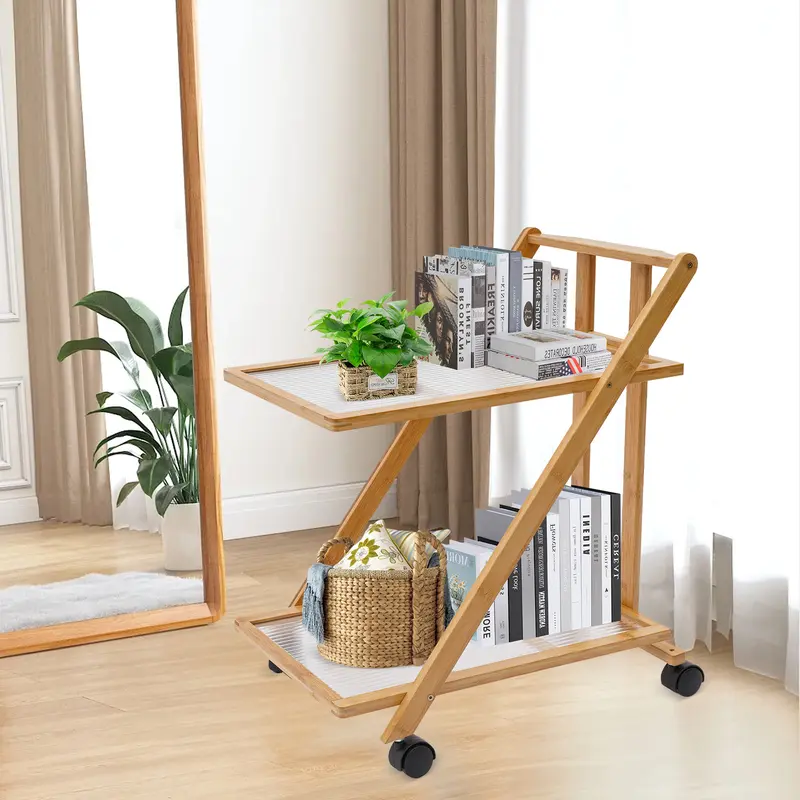 Two-tier folding bamboo cart with books beside a sofa