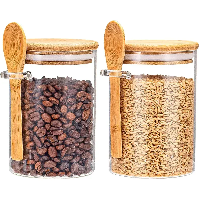Two glass jars with wooden spoons and lids