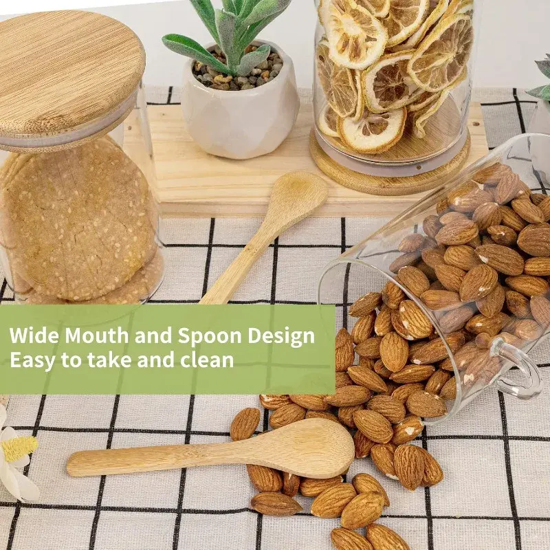 Two glass jars with wooden spoons and lids