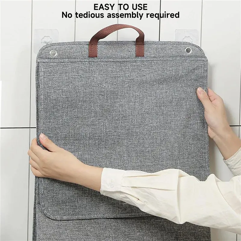Gray foldable laundry hamper hanging on a bathroom wall