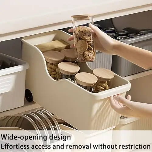 Beige plastic pull-out bins on wheels in an under-sink cabinet