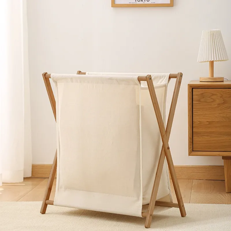 Small gray foldable laundry basket with a wooden frame