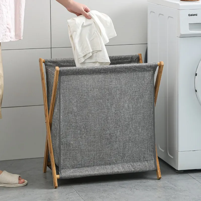 Small gray foldable laundry basket with a wooden frame