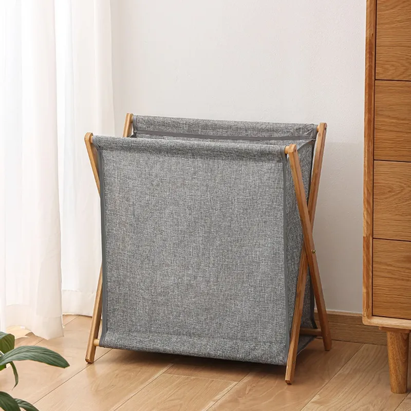 Small gray foldable laundry basket with a wooden frame