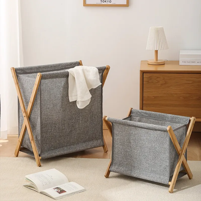 Small gray foldable laundry basket with a wooden frame