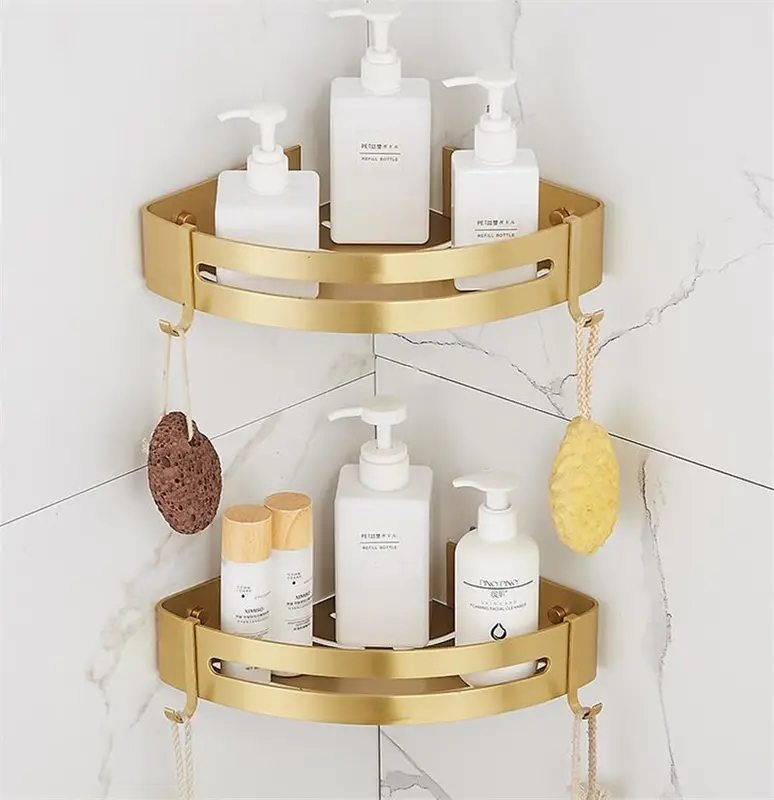 Brushed gold corner shelves holding shampoo bottles