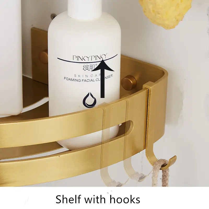 Brushed gold corner shelves holding shampoo bottles