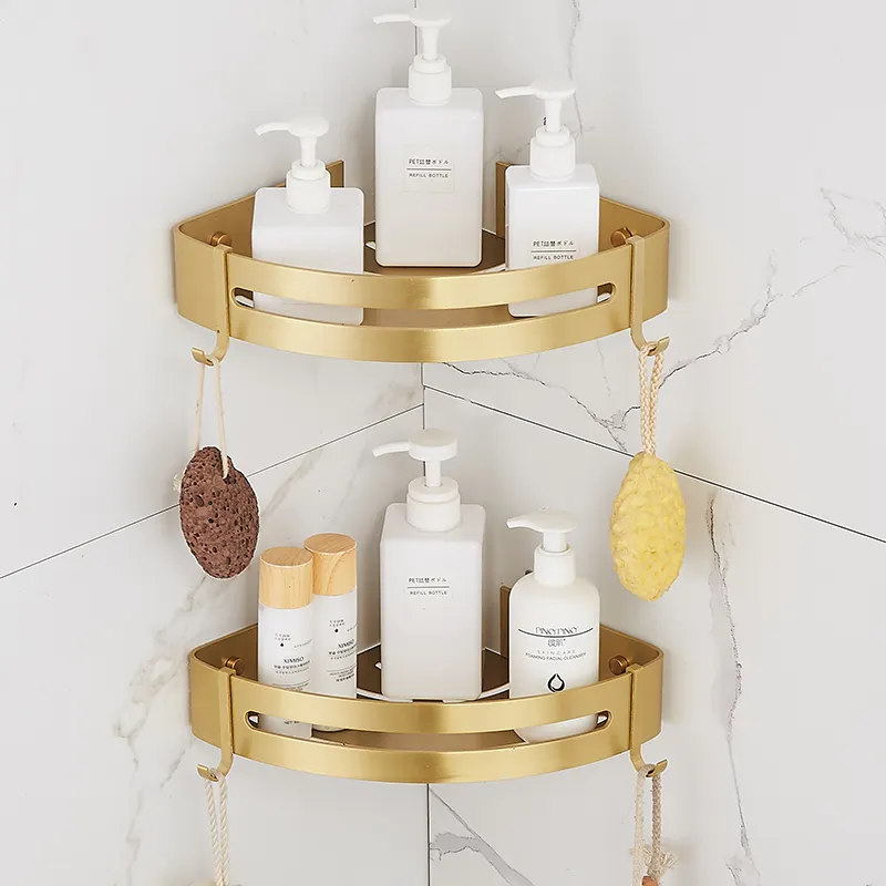 Brushed gold corner shelves holding shampoo bottles