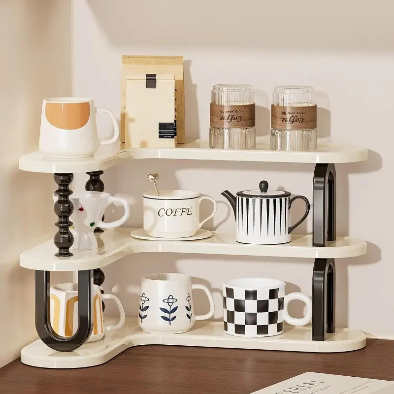 White curved three-tier shelf holding cups and coffee jars