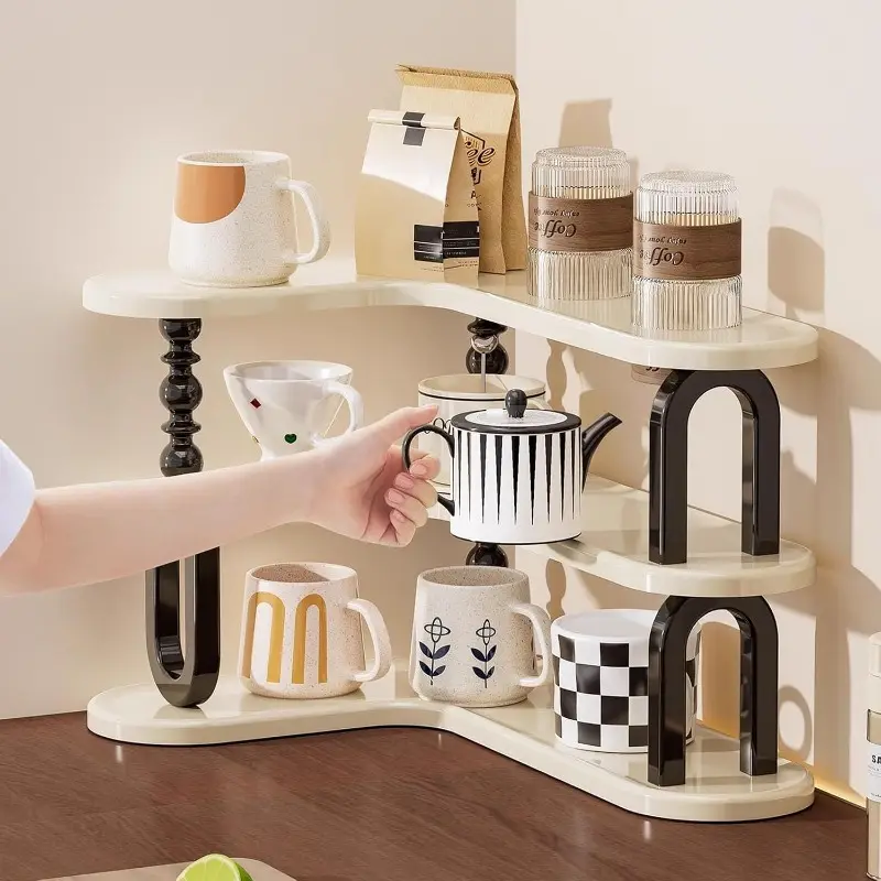 White curved three-tier shelf holding cups and coffee jars