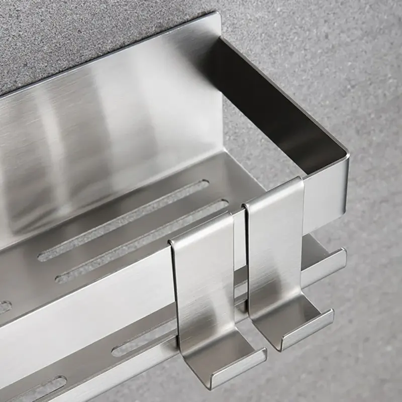 Silver stainless steel shower basket with hooks on a wall