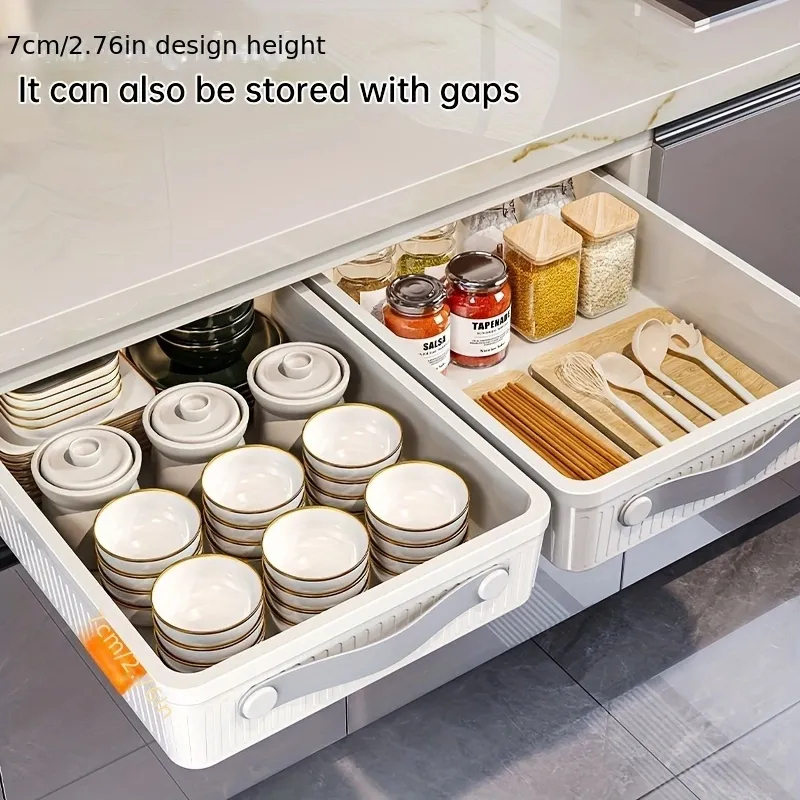 Large pull-out plastic basket in a kitchen cabinet