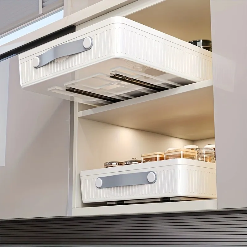 Large pull-out plastic basket in a kitchen cabinet