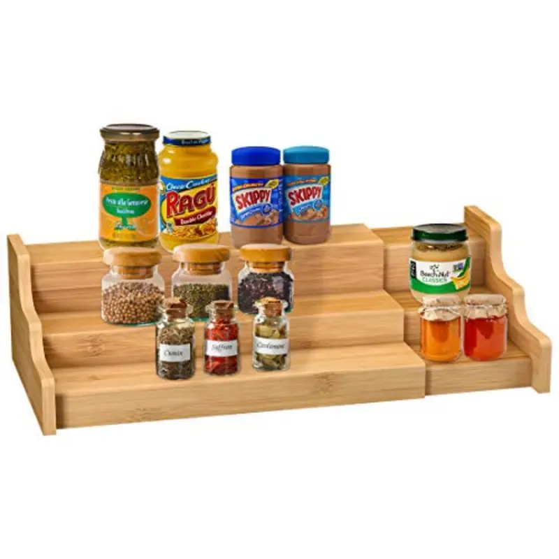 Three-tier expandable bamboo spice rack holding jars